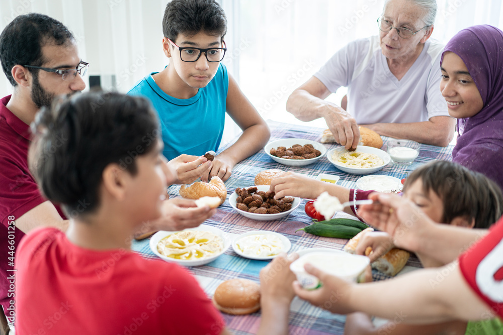 Happy family enjoying eating food in dining room Happy family enjoying eating food in dining room
