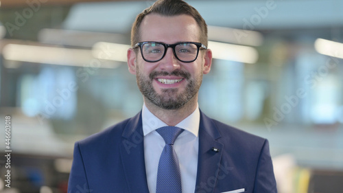 Portrait of Middle Aged Businessman Smiling at Camera