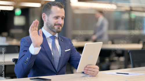 Online Video Chat via Tablet by Middle Aged Businessman