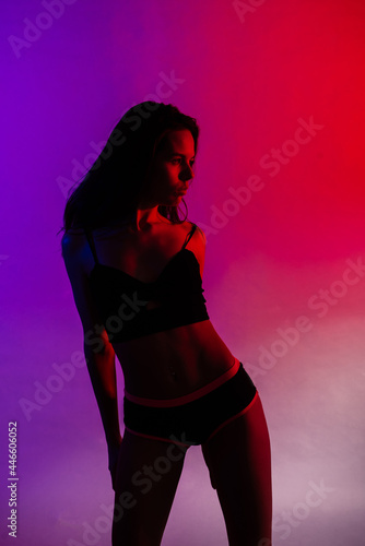 Modern style dancer posing on studio background