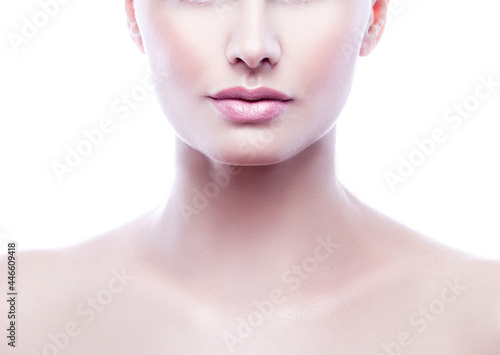 Lips and part of face of model girl with natural nude make-up and clean wet skin over white background