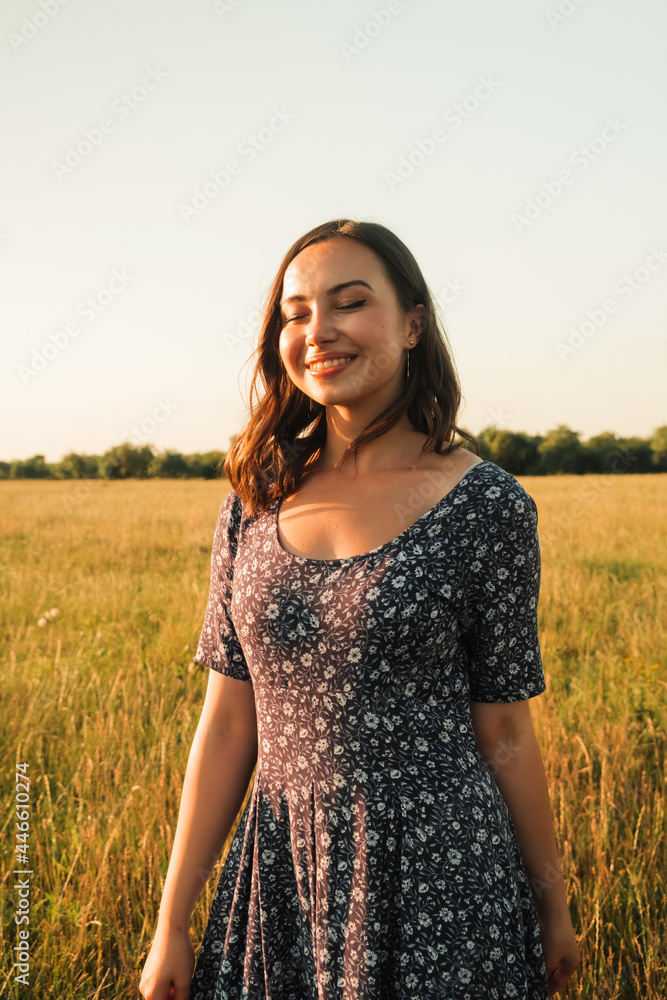 a happy girl with long black hair in a wheat field. He enjoys the happy moments of his life. High quality photo a happy girl with long black hair in a wheat field. He enjoys the happy moments of his life. High quality photo