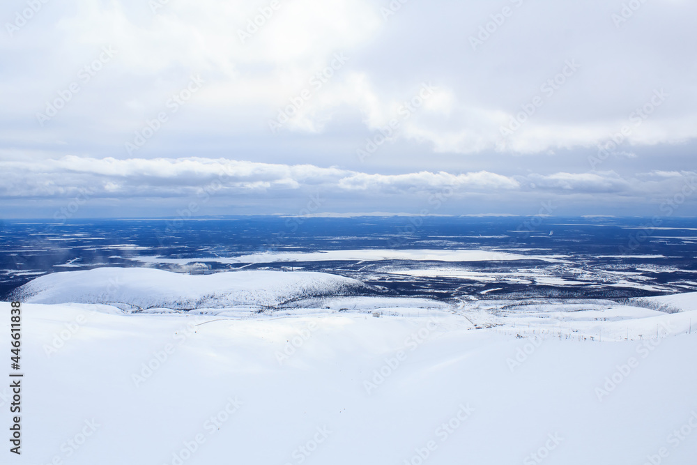 cloudy sky and arctic winter landscape from the mountain above the Arctic Circle in Russia