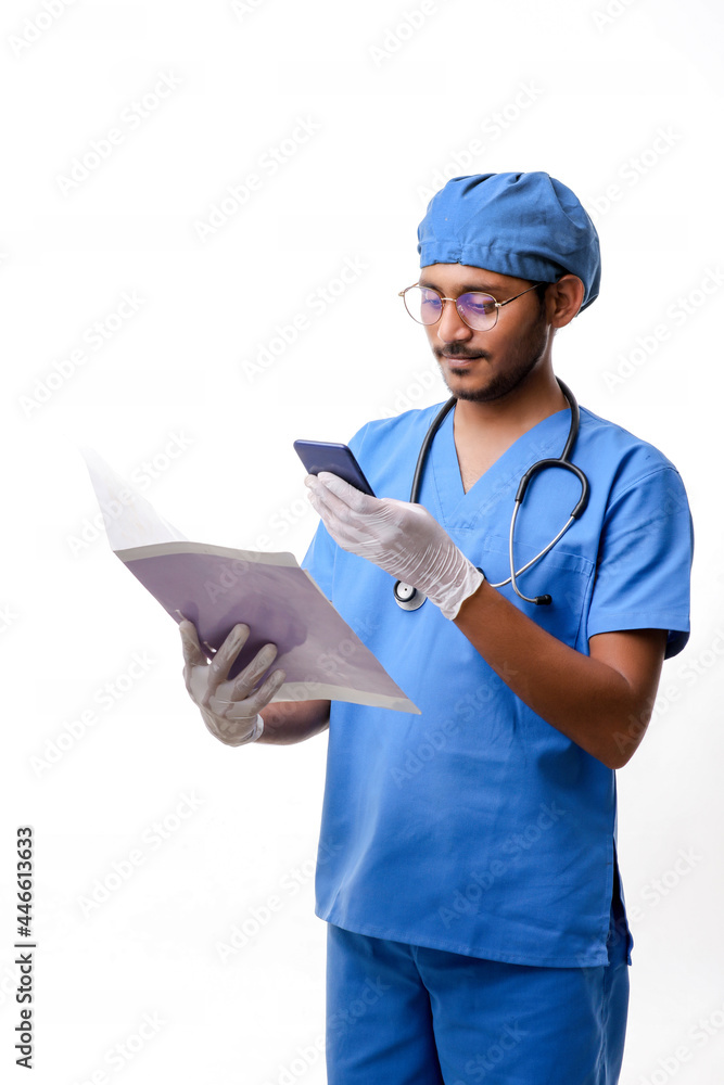 Young indian doctor using smartphone over white background. Young indian doctor using smartphone over white background.