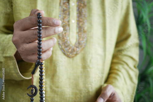 muslim man keep hand in praying gestures during ramadan, Close up 