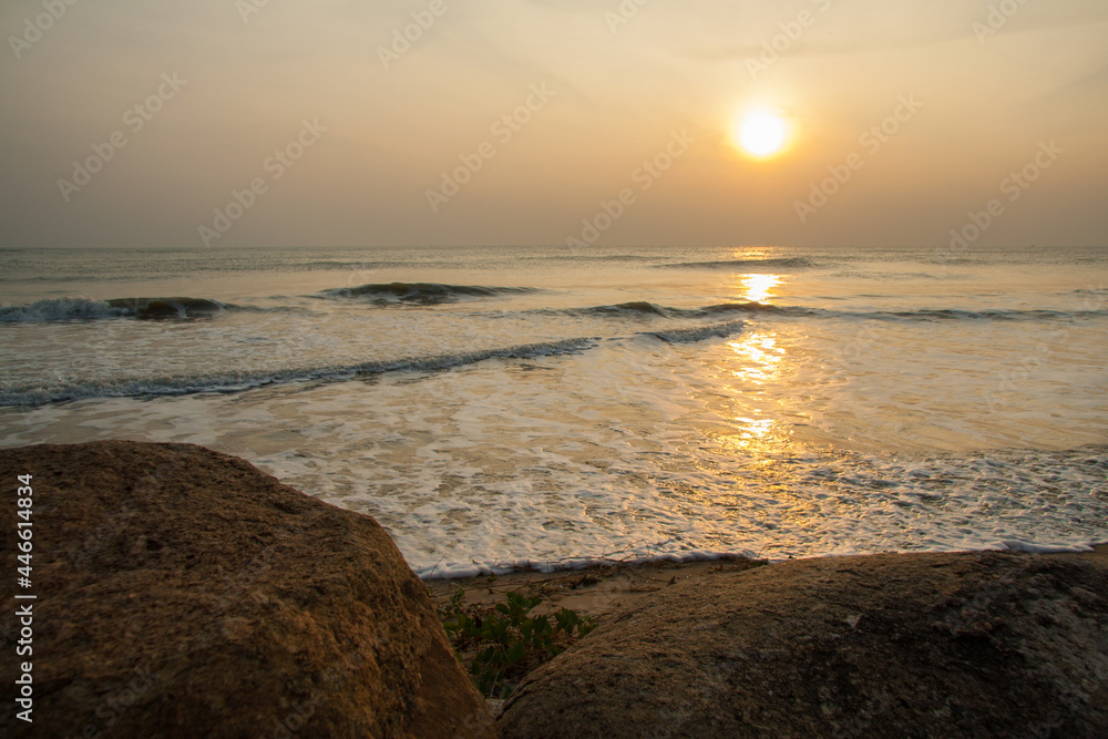 Sea wave surface on sunset with rock on front Sea wave surface on sunset with rock on front