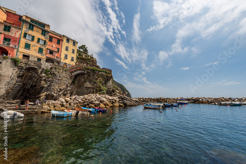 The famous Riomaggiore village with small boats moored in the port, Cinque Terre National Park in Liguria, La Spezia, Italy, Europe. UNESCO world heritage site.