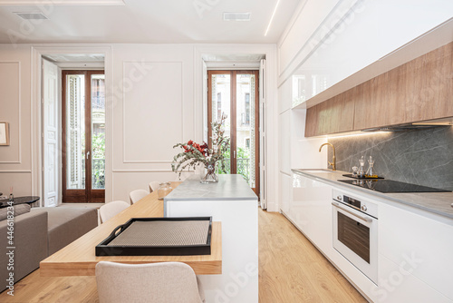 Contemporary kitchen with oak island as a dining table in a vacation rental apartment