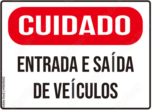 A sign that says in Portuguese language   caution entry and exit of vehicles