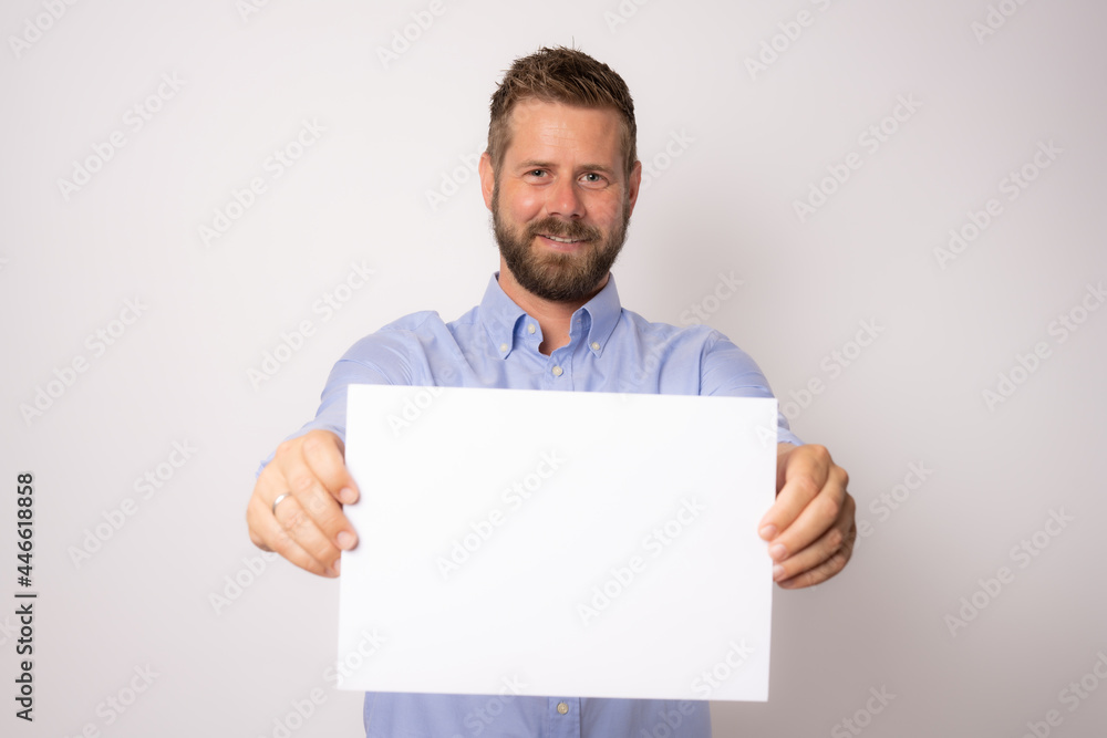 Portrait of happy smiling young business man showing blank signboard over white background. Portrait of happy smiling young business man showing blank signboard over white background.