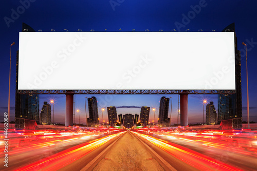 Blank billboard on light trails, street and urban in the night - can advertisement for display or montage product or business.