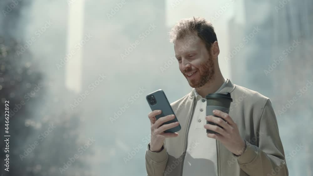 Stylish man using cell phone while standing outdoors Stylish man using cell phone while standing outdoors