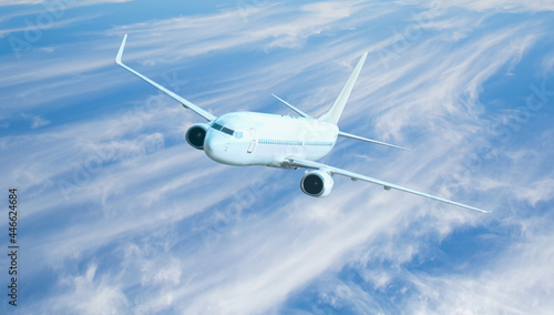 Fototapeta Naklejka Na Ścianę i Meble -  White passenger airplane over the clouds  - Travel by air transport