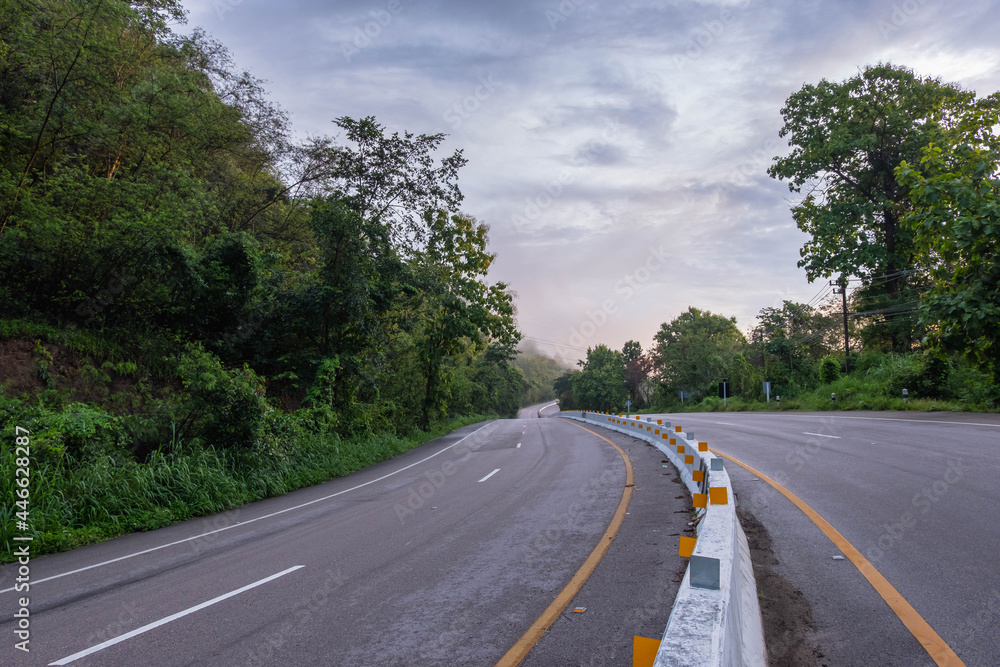 Naklejka premium A long and winding road with nature along the way.