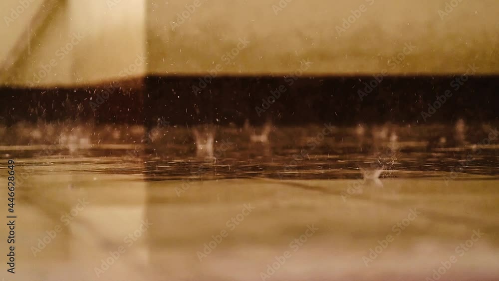 Heavy rain fall. closeup rain drops fall into a puddle of water on stone paving slabs. Heavy rain fall. closeup rain drops fall into a puddle of water on stone paving slabs.