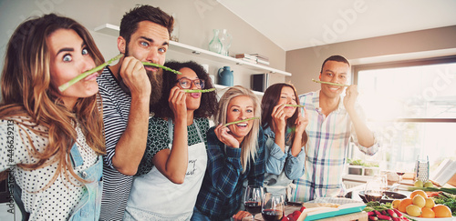 Group of chefs playing with asparagus stalks