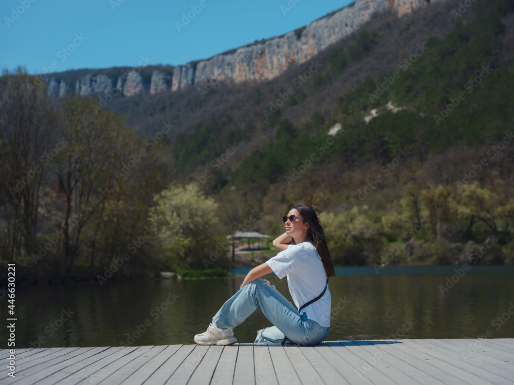 Young woman enjoying beauty of nature of mountain lake.