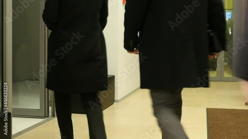 Male and female legs, people walking at office