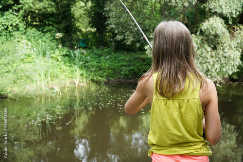 fishing rod a girl fishing in the summer in a pond holds