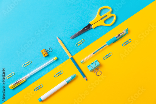 Blue and yellow office supplies on background. Flat lay. Back to school. Education and bussines concept