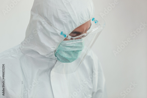 Asian Doctor, nurse and staff wearing surgical face mask face shield and protective hazmat suit working in the hospital during Coronavirus covid 19 pandemic