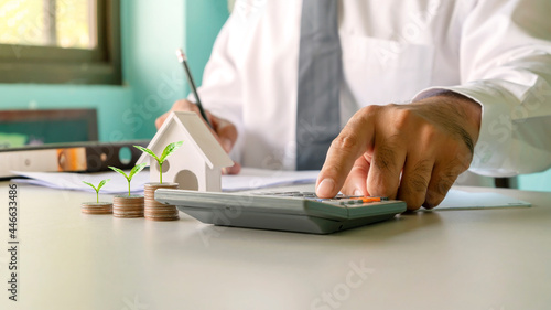 A businessman calculating income-expense and analyzing real estate investment data. Accounting, Finance and Tax System Concepts