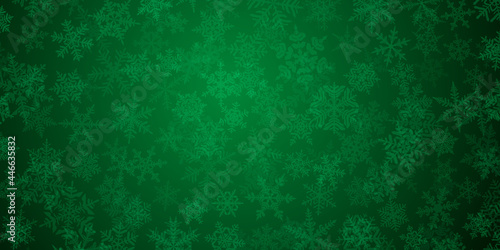Background of complex translucent Christmas snowflakes in green colors. Winter illustration with falling snow