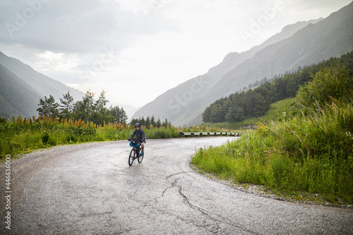 Bicyclist at rainy on the mountain road