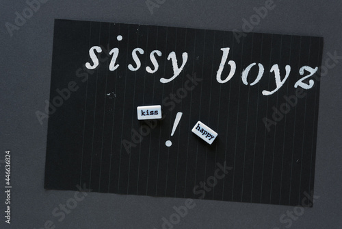 stencilled words "sissy boyz" with word beads "kiss" and "happy" and a exclamation mark on black