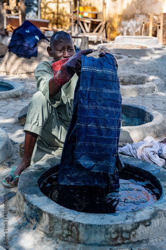 Man dyeing clothes with Indigo, Dyeing pits, Kano, Kano state, Nigeria, West Africa, Africa