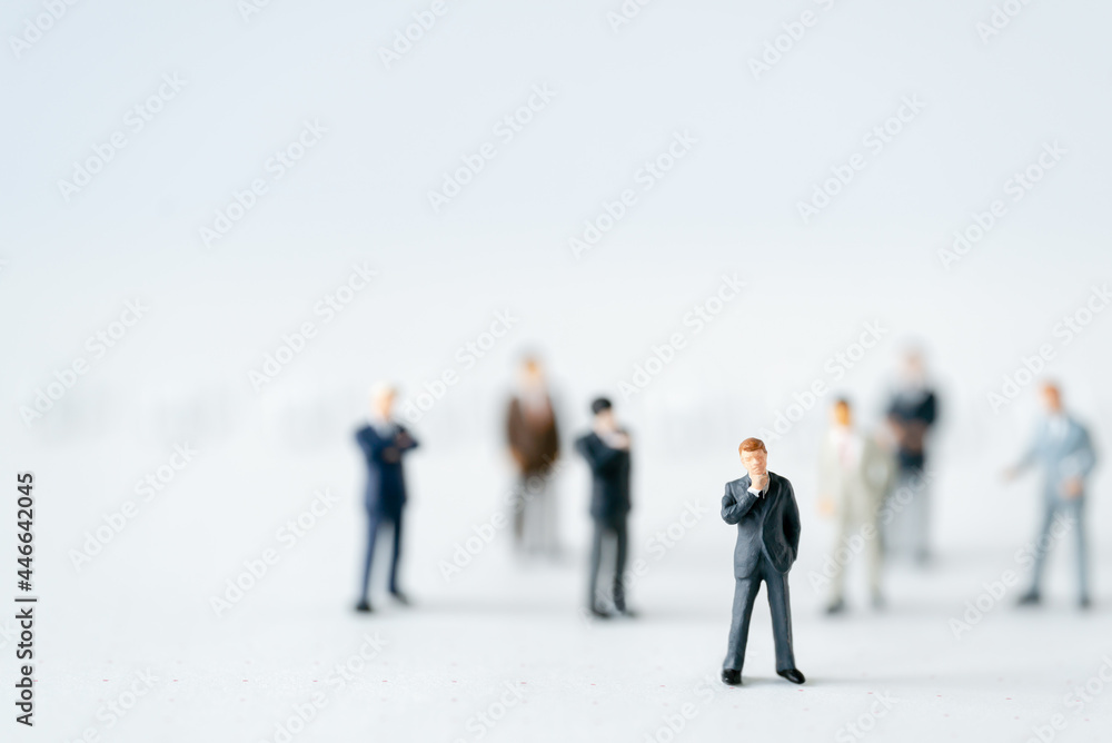 Miniature businessman planning thinking success deal business on white background using as commitment, insurance agreement, travel investment and partnership business development joint venture concept Miniature businessman planning thinking success deal business on white background using as commitment, insurance agreement, travel investment and partnership business development joint venture concept