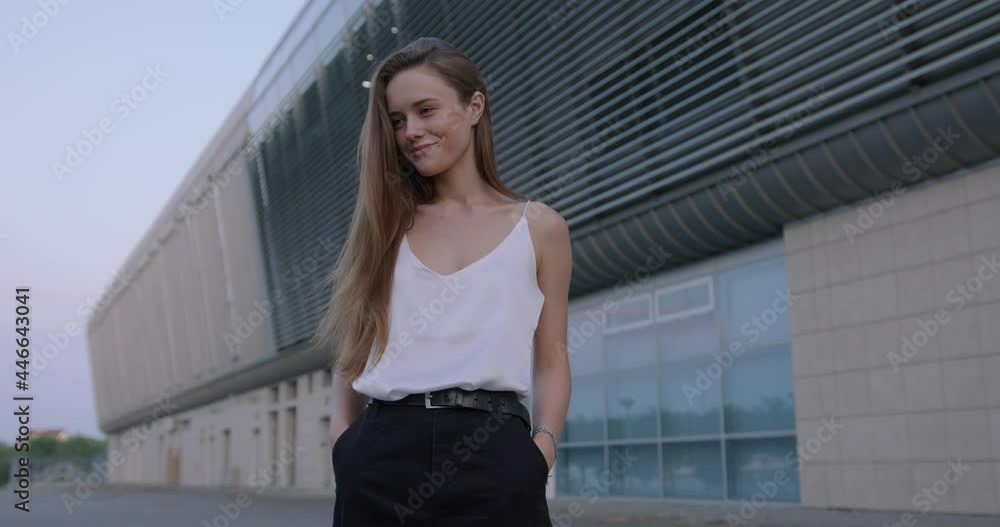 Young woman with hands in pockets standing on street Young woman with hands in pockets standing on street