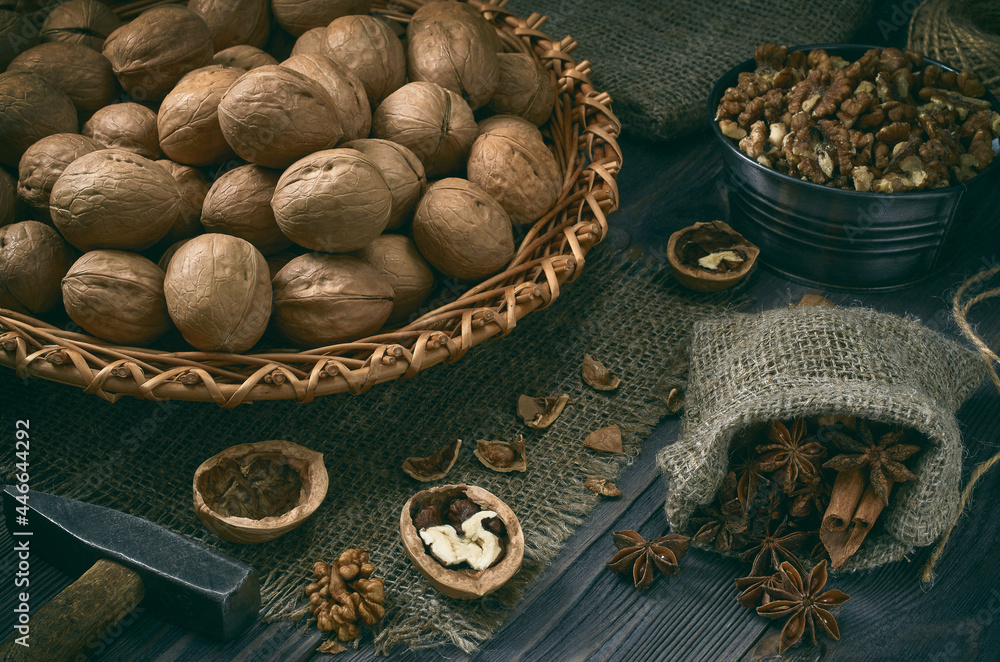 Wicker dish with walnuts on a dark wooden table. Wicker dish with walnuts on a dark wooden table.