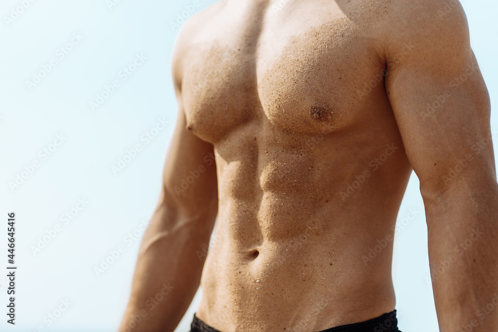 Fototapeta premium Portrait of strong healthy sporty man, training athlete outdoors, handsome sporty man outdoors on the beach