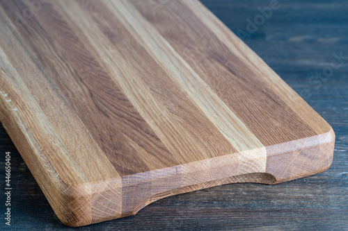 Wooden cutting board on wooden table background
