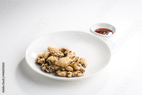Fried breaded mushrooms with dip sauce isolated on white background