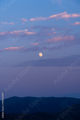 Portrait of the moon through clouds over the Sun Valley Idaho High Desert during Sunset