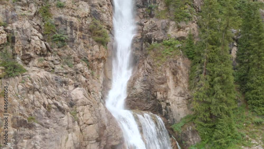 Aerial view of Burkhan Bulak waterfall. Burkhan-Bulak is the highest waterfall in Kazakhstan. Mountains of the Dzhungarskiy Alatau. The camera moves from bottom to top of the waterfall. Aerial view of Burkhan Bulak waterfall. Burkhan-Bulak is the highest waterfall in Kazakhstan. Mountains of the Dzhungarskiy Alatau. The camera moves from bottom to top of the waterfall.