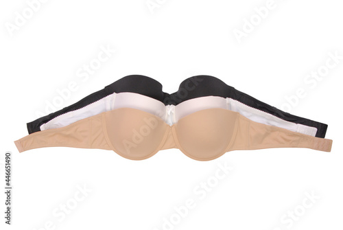 three strapless bras, black white  flesh-coloured bra, assortment of underclothes, pile of brassieres, isolated heap female underwear, beige undergarment