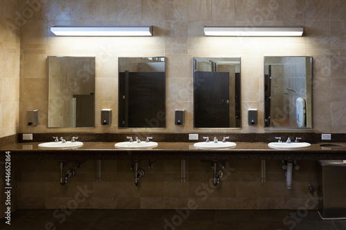 Public bathroom tiled interior sinks and mirror