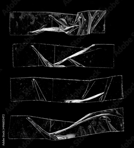 Картината върху платно set of transparent adhesive tape or glue strips isolated on black background, crumpled plastic sticky snips, real macro photo