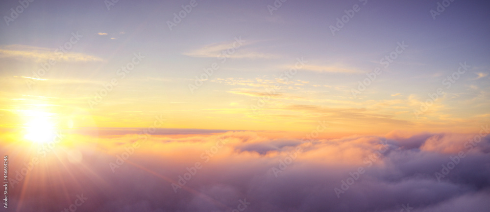 Panoramic view above clouds with beautiful sunset.