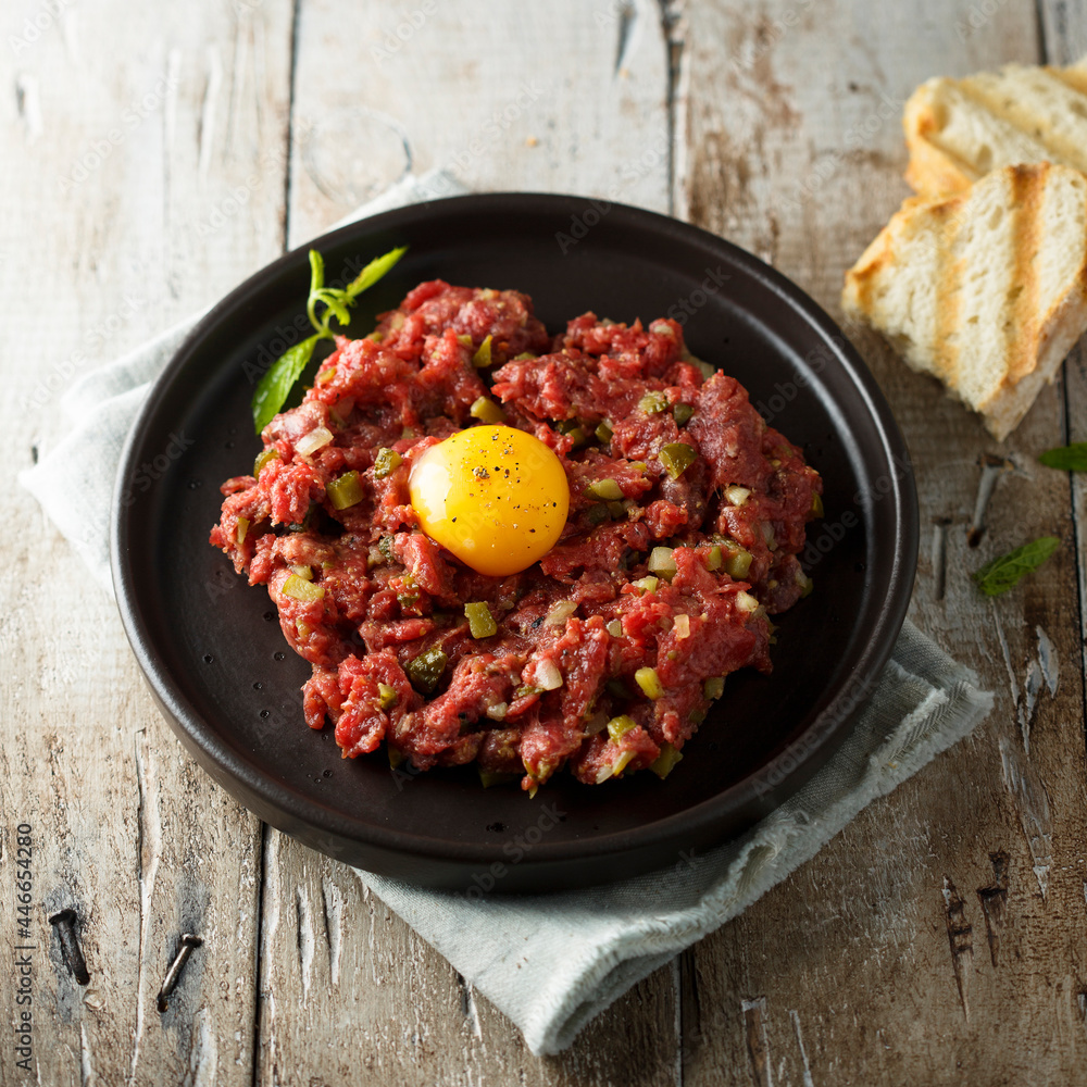 Traditional beef steak tartare with egg yolk Traditional beef steak tartare with egg yolk