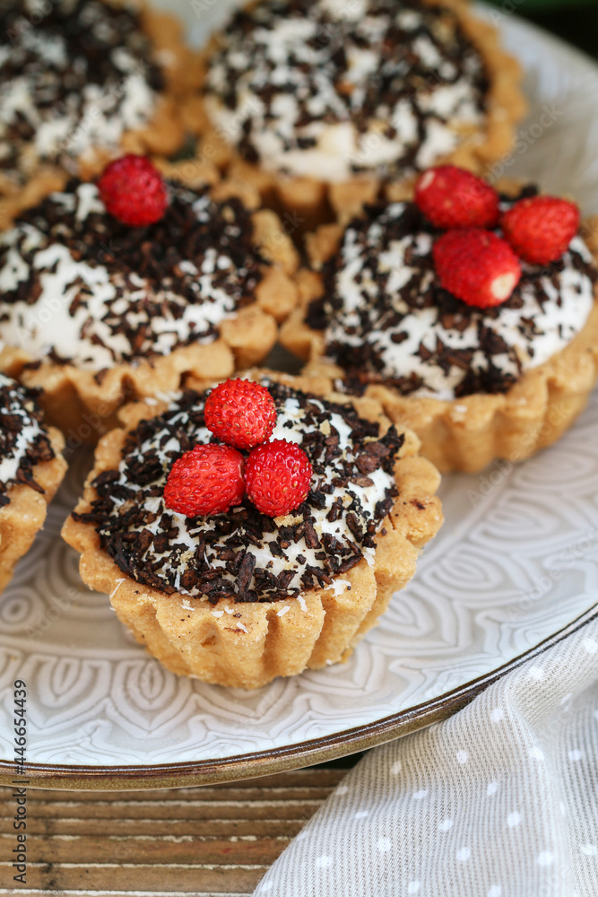 Tiny cupcakes with chocolate on the table.
