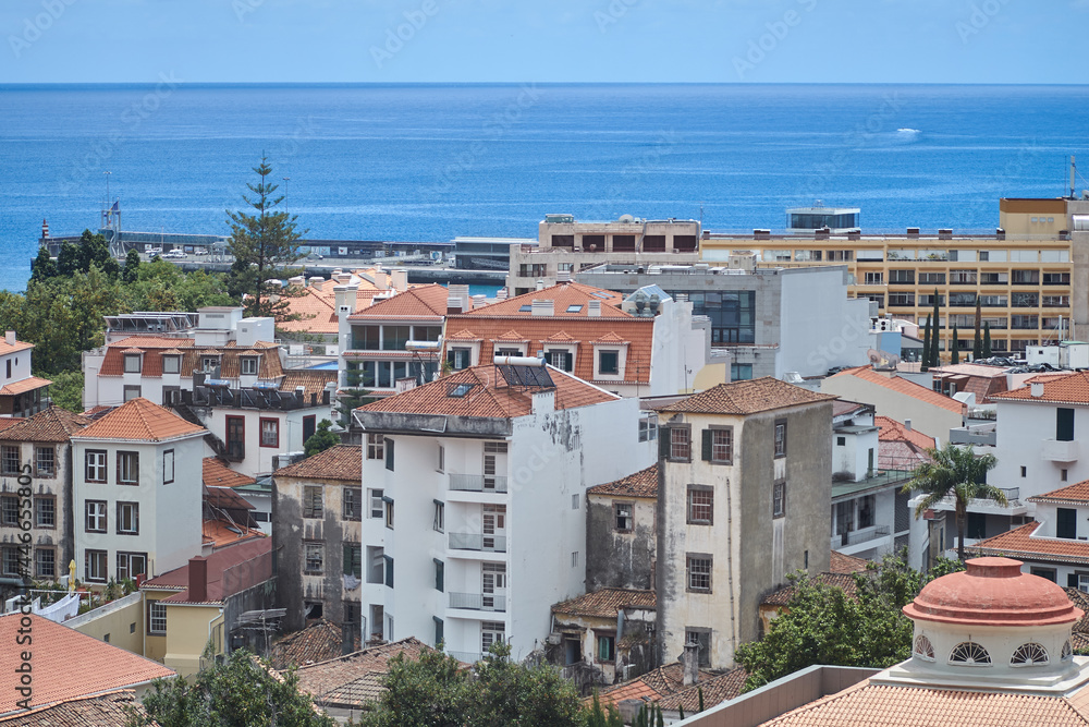 funchal city old buildings, architecture madeira island, densely populated cityscape, atlantic ocean sea on background