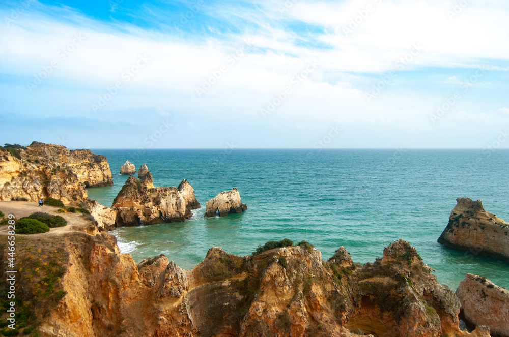 A view of cliffs meeting turquoise water at the coastline of Atlantic Ocean, Partimao, Portugal