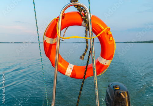 Sailing boat on a calm lake with reflection in the water. Serene scene landscape. Vertical photograph.