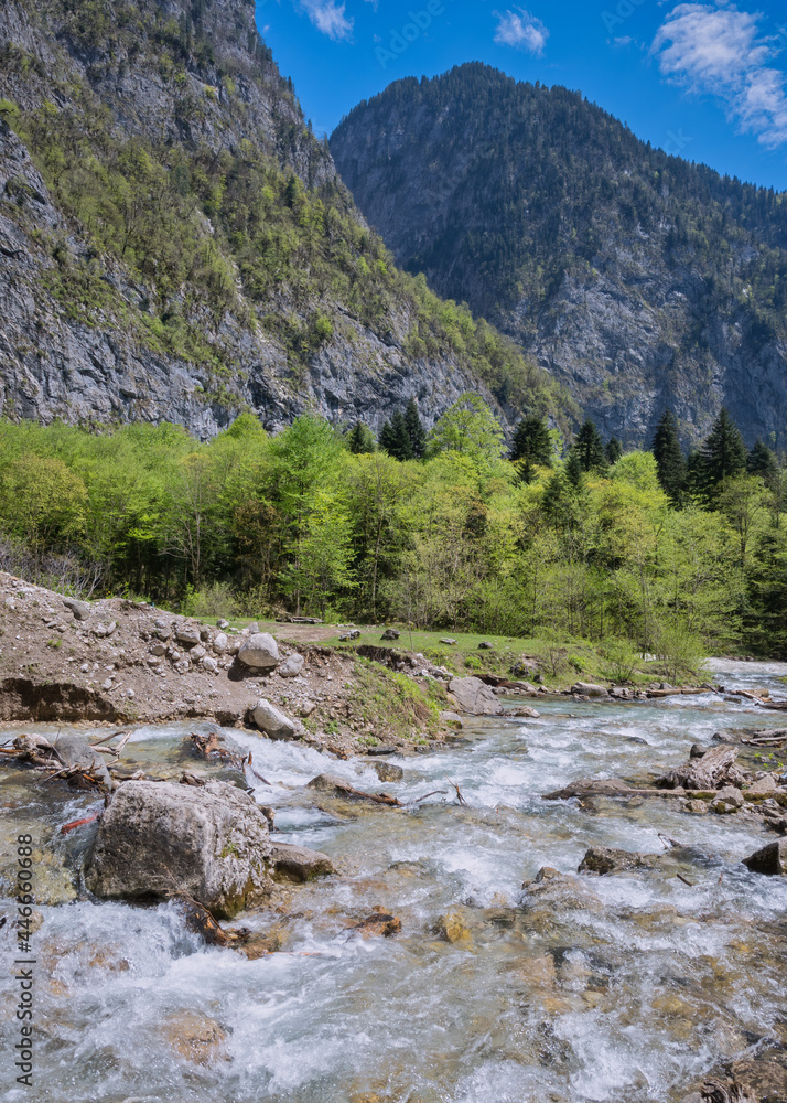 The rushing stream of the Gega river in springtime flows along a rocky riverbed. Abkhazia, near Gega Waterfall. Scenic destination, about 530 m about sea level. Travel, tourism, nature conservation. The rushing stream of the Gega river in springtime flows along a rocky riverbed. Abkhazia, near Gega Waterfall. Scenic destination, about 530 m about sea level. Travel, tourism, nature conservation.