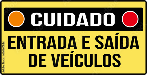 A sign that says in Portuguese language : caution entry and exit of vehicles
