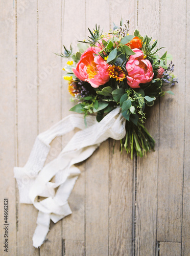 overhead view of romantic colorful wedding bouquet on wood background